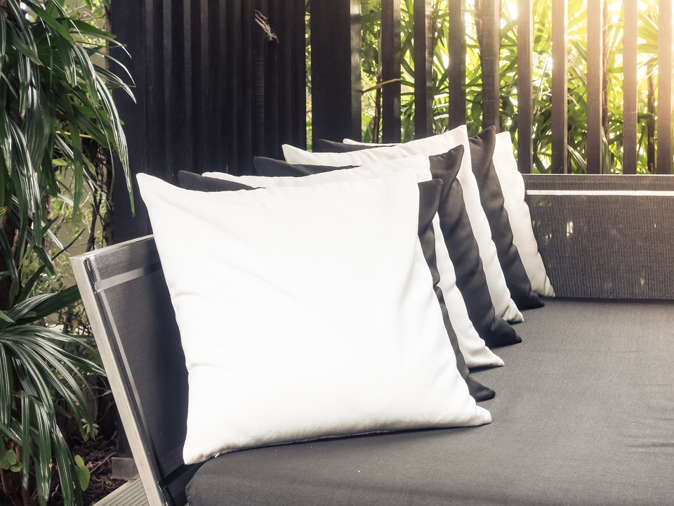Beautiful pillow on sofa decoration with outdoor deck - Sunflare Effect